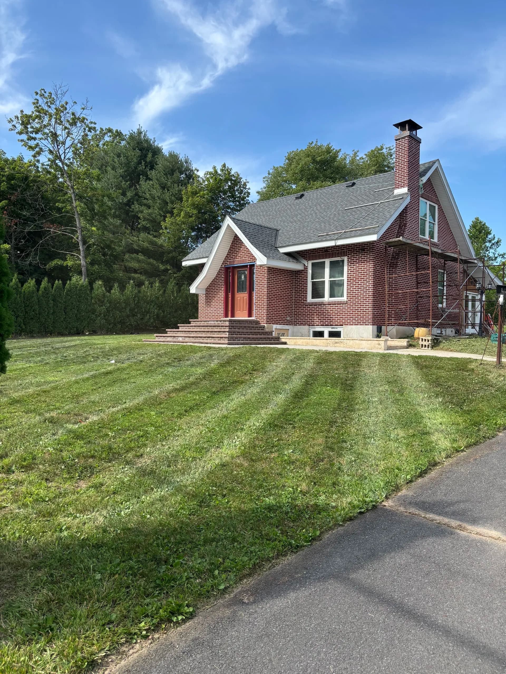Freshly mowed lawn and brick home maintained by Firefly Lawn & Land