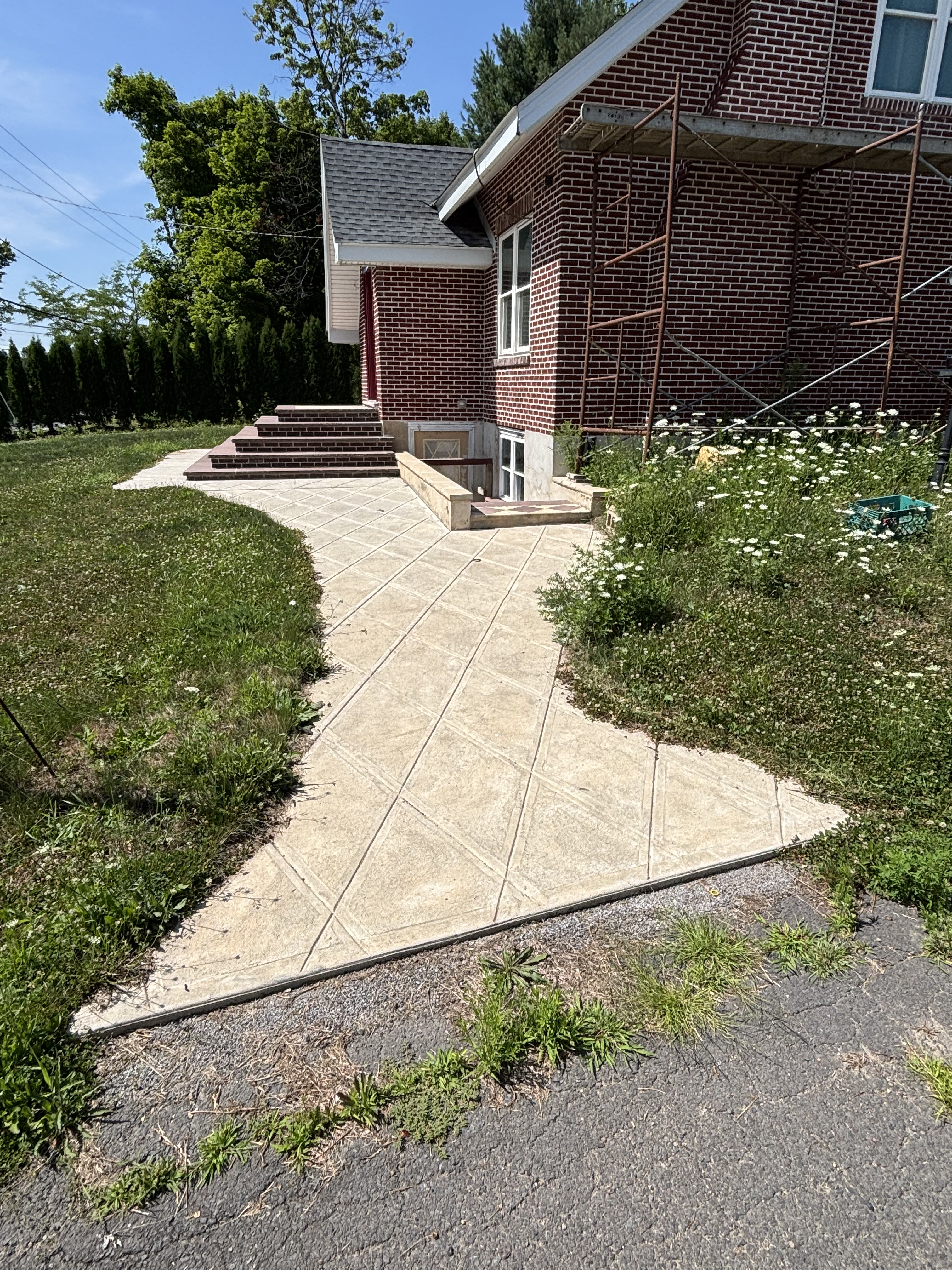 Cracked driveway approach before walkway work
